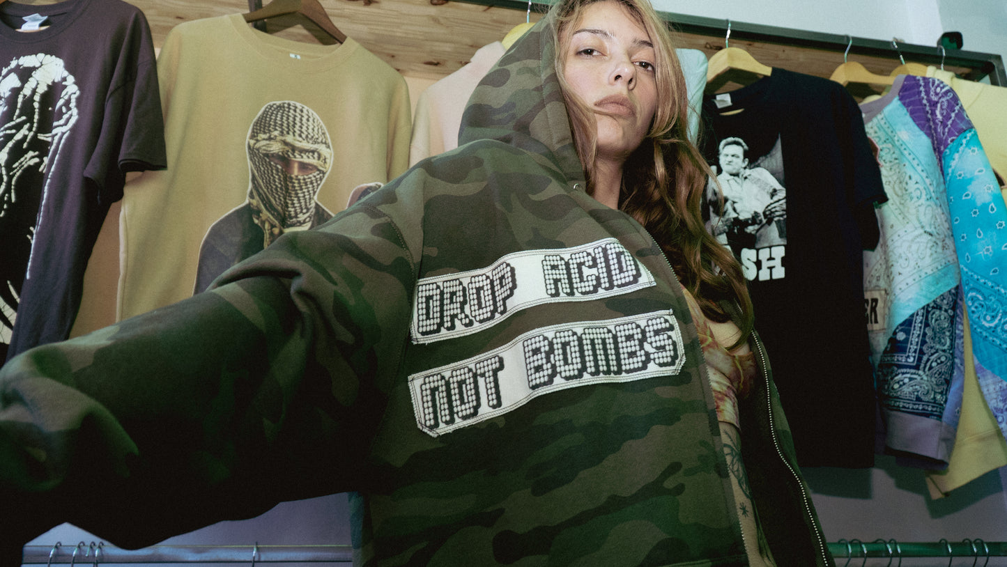 Camo zip up hoodie with Pigpen and Drop Acid Not Bombs patches, size Men’s XL